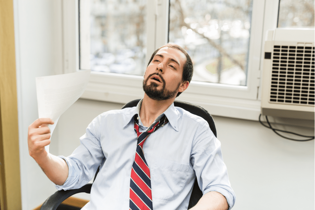 Man in office sweating