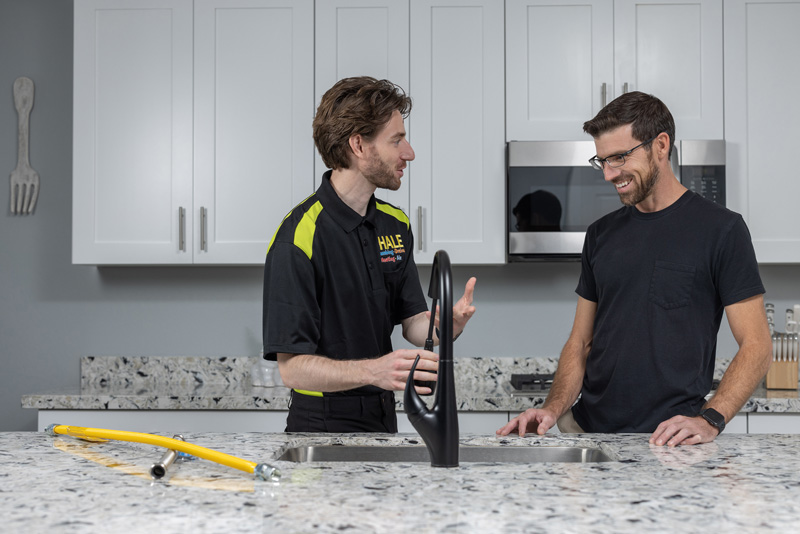 Scott Hale plumbers working on kitchen sink