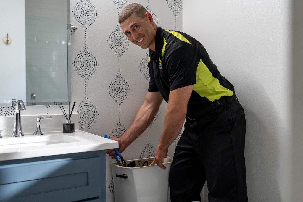 plumber working on toilet