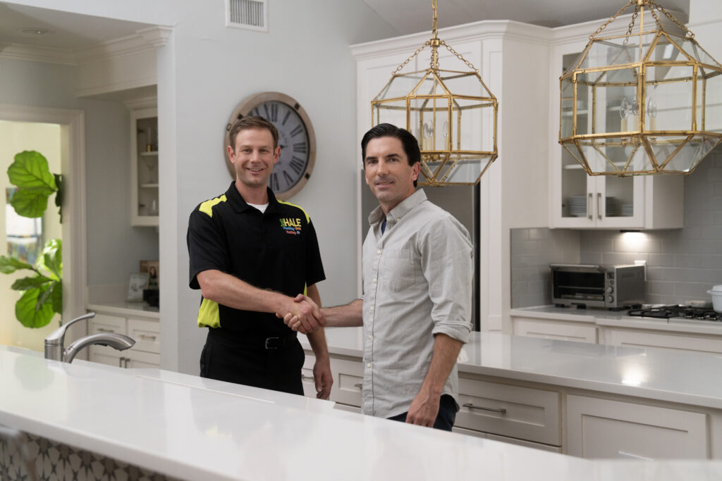 plumber greeting customer in kitchen
