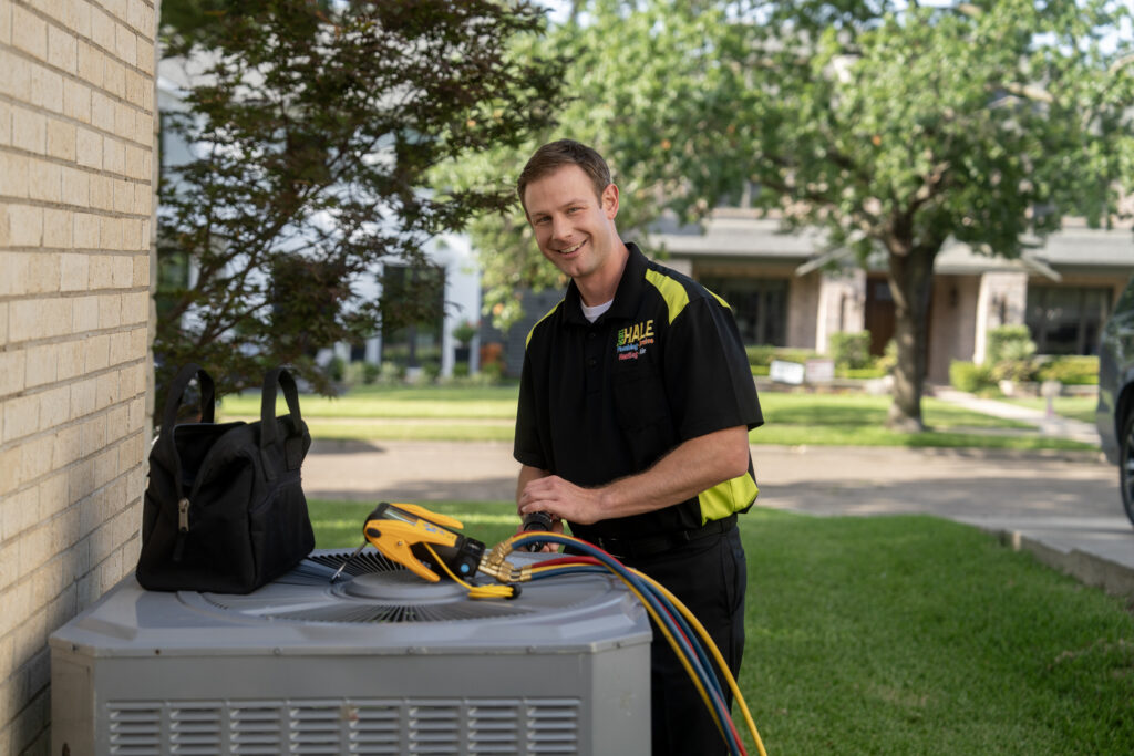 HVAC repair tech working on heat pump