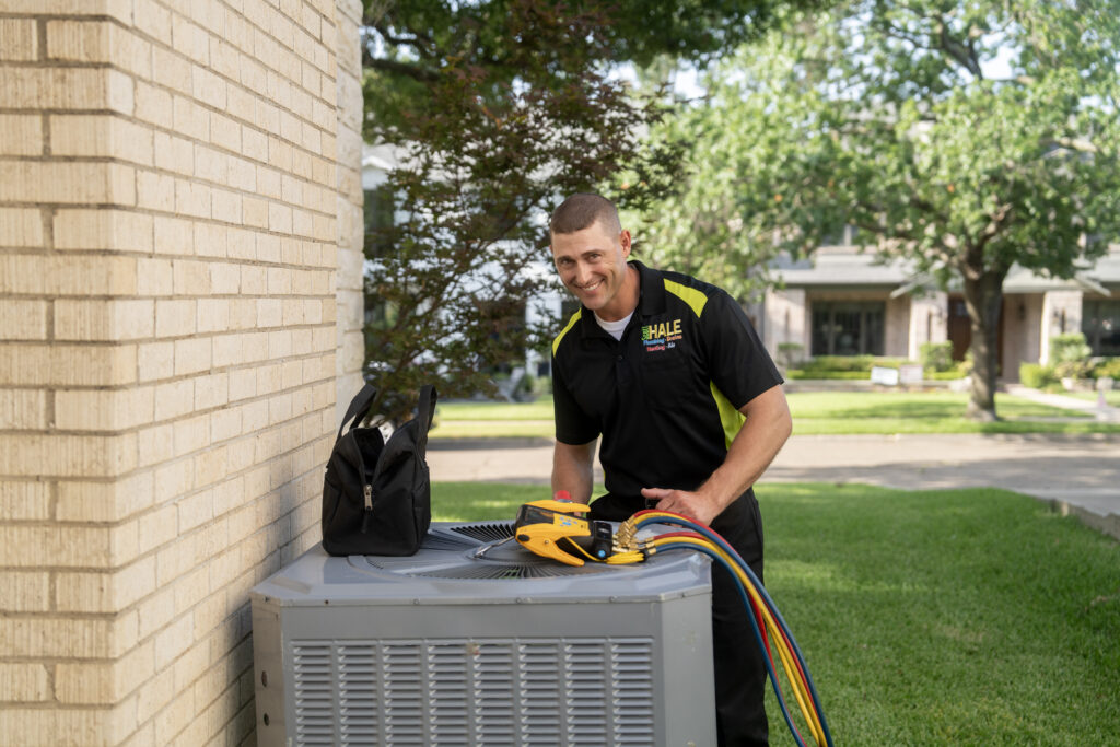 HVAC tech inspecting heat pump